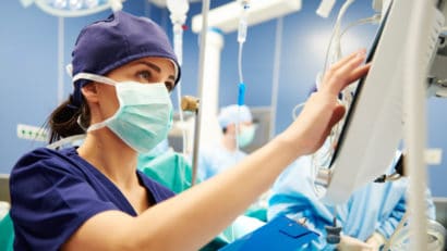 Nurse working with technology in operating room